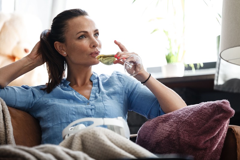 kobieta pijąca wini na sofie dla relaksu